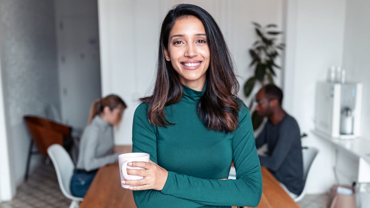 young business professional standing in a conference room