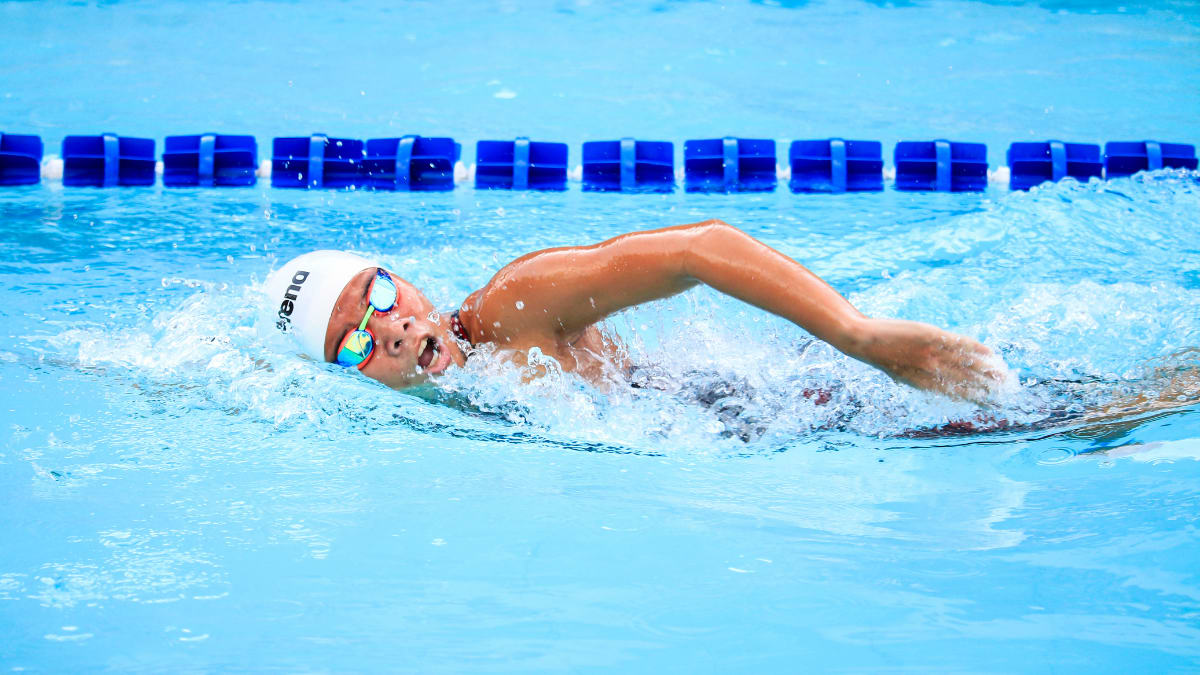 swimmer doing a freestyle during a competition