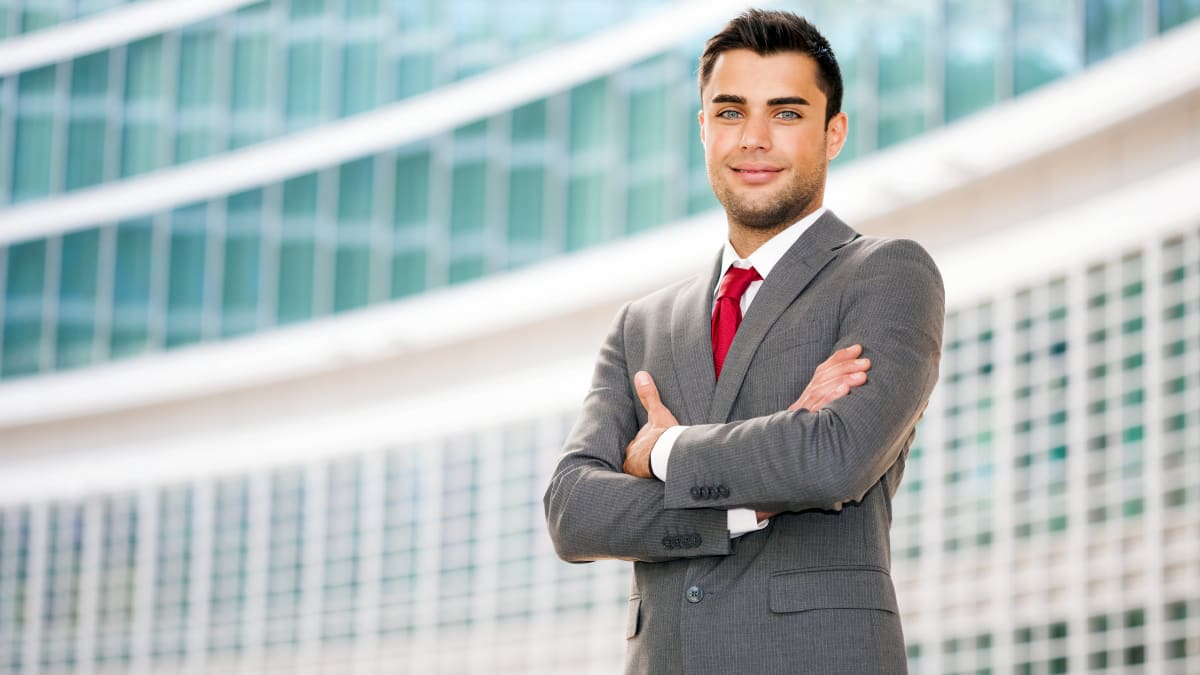 young business professional standing outside an office complex