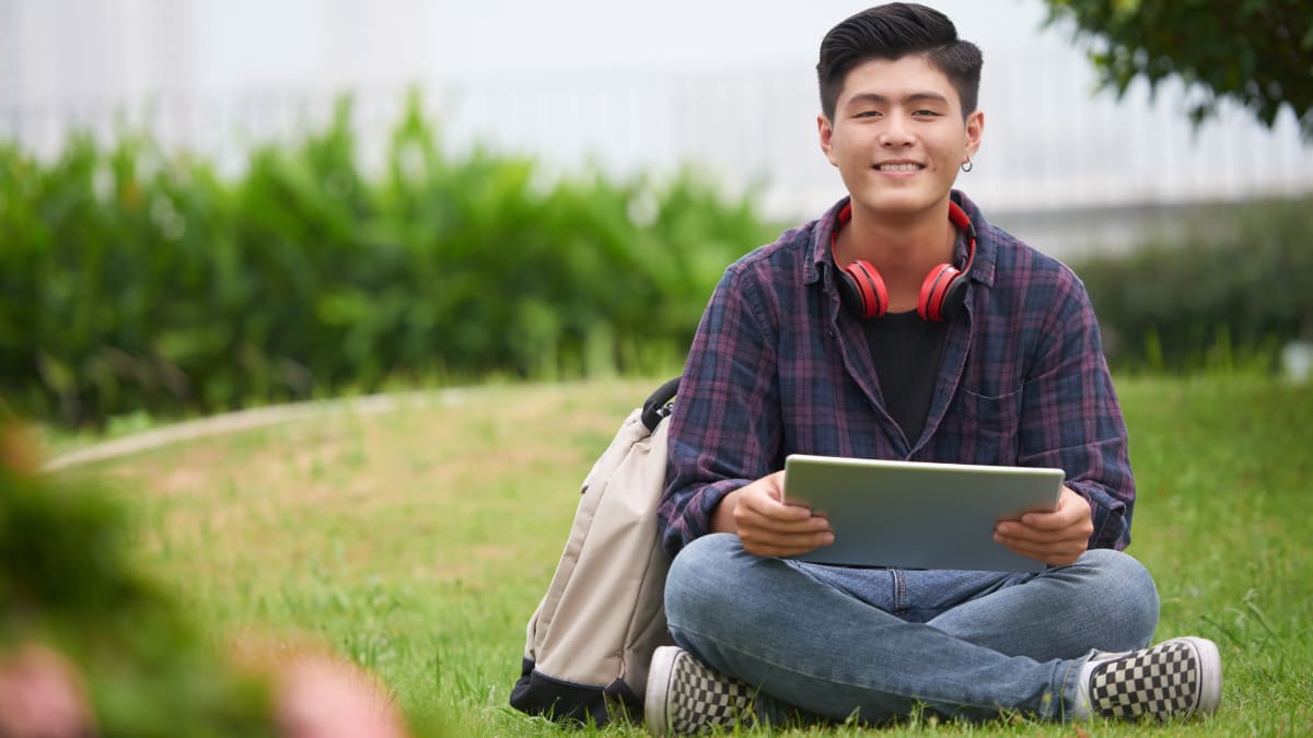 college student sitting outside on a college campus