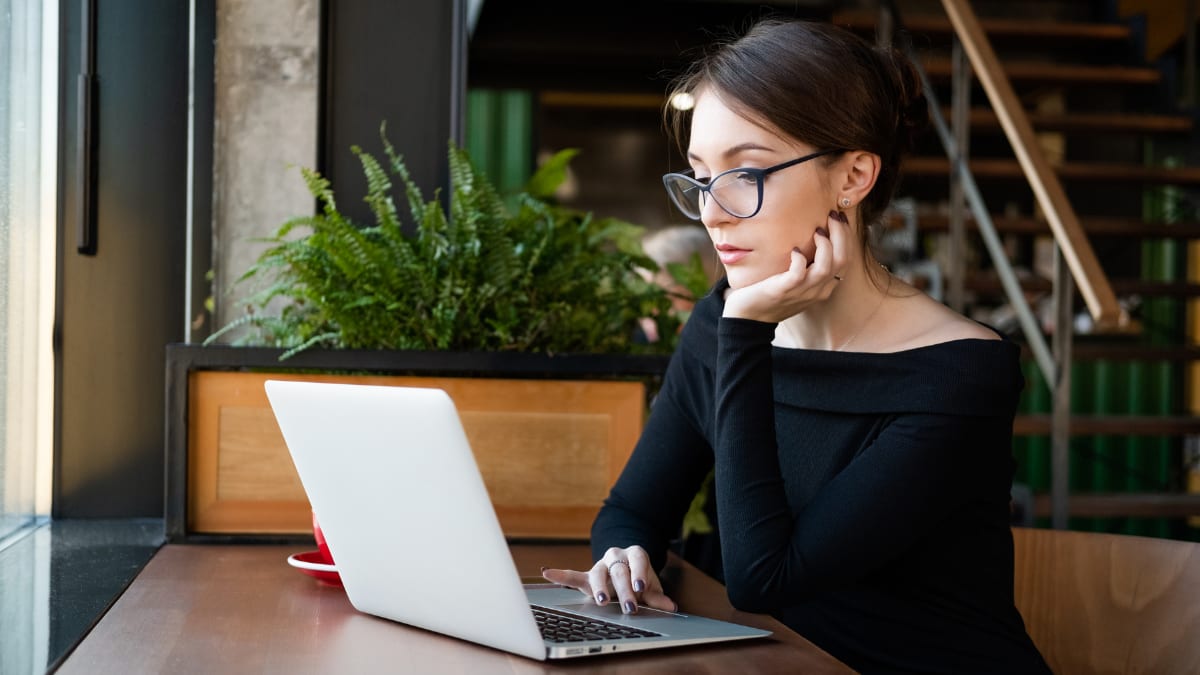 young business professional working on an online MBA on a laptop