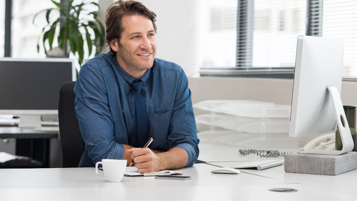 young business professional sitting at a desk in an office