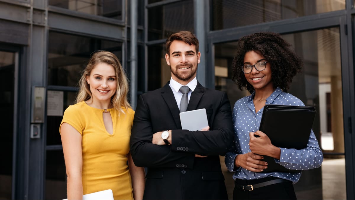 young business professionals standing outside an office building