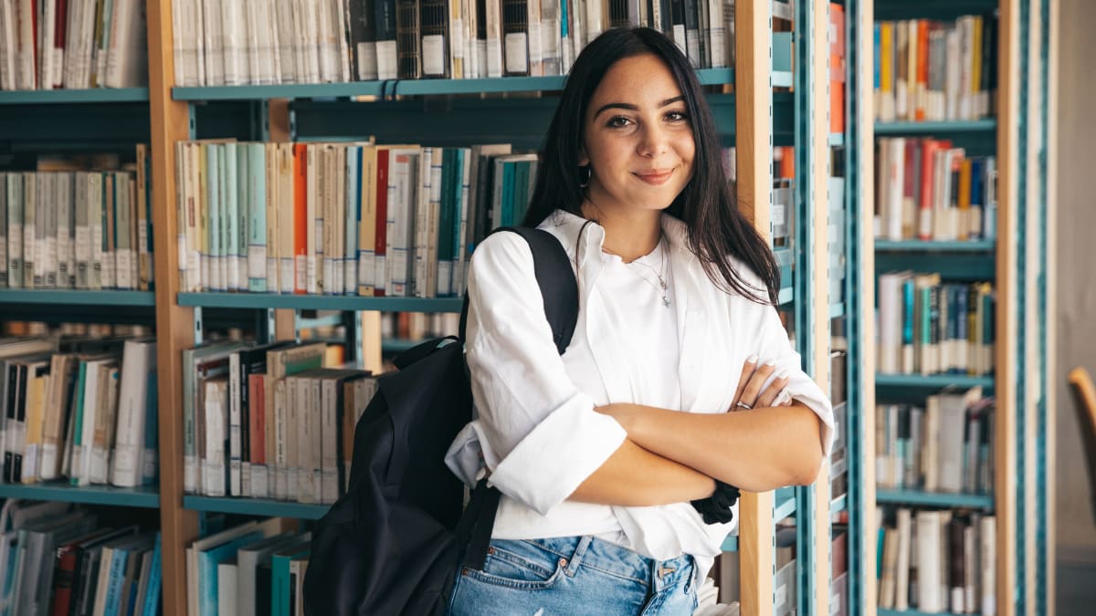 student standing in a library