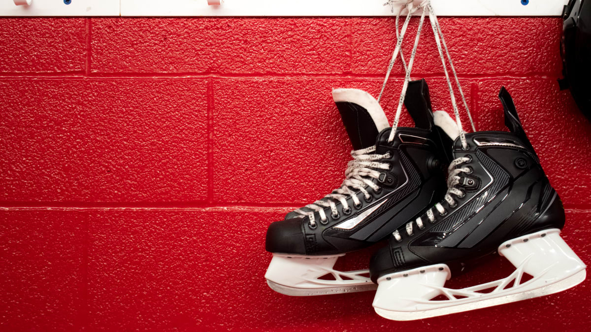 ice skates for hockey hanging on a wall