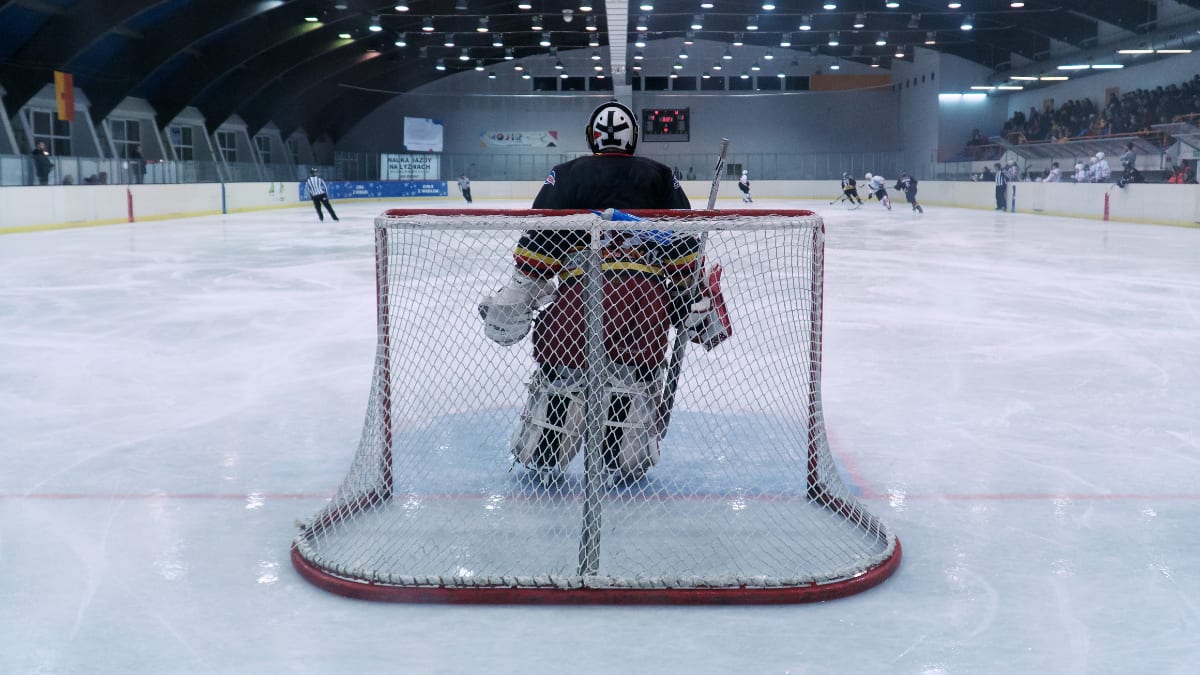 a goalie protecting the net in a hockey game