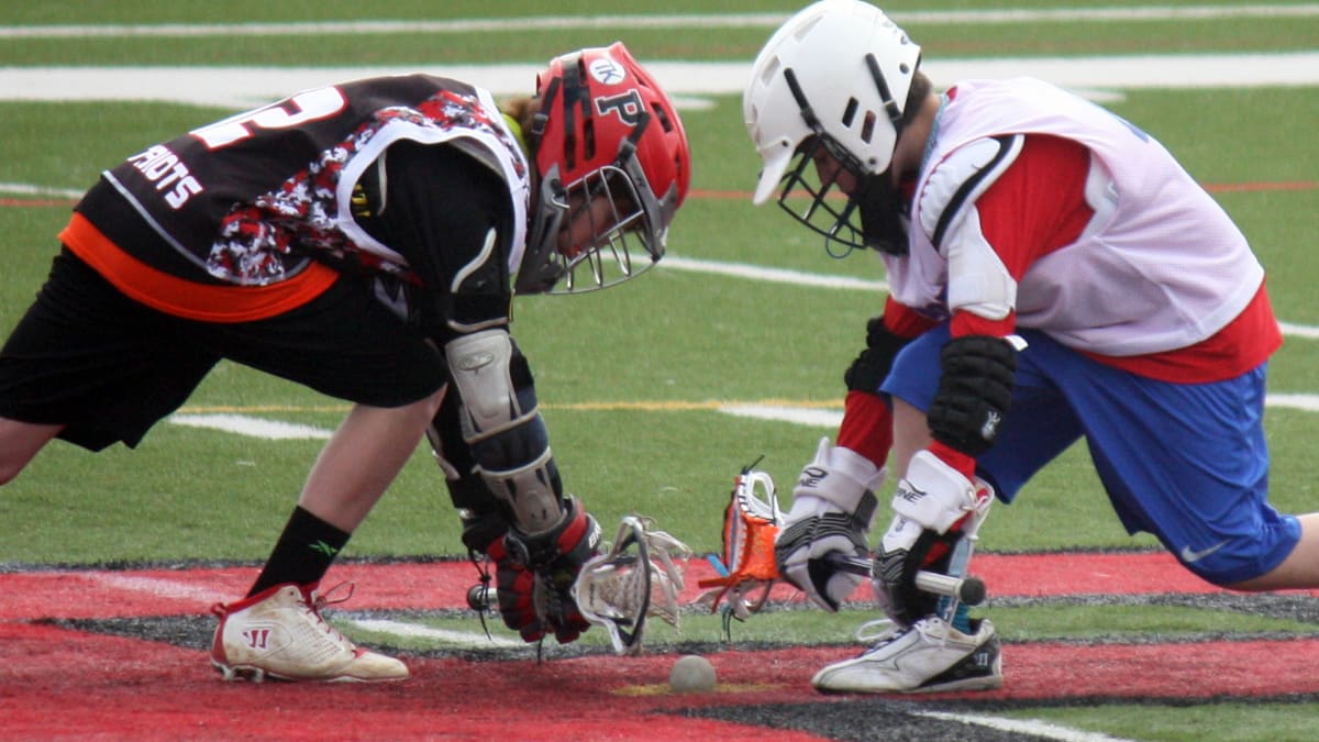 two lacrosse players in a game