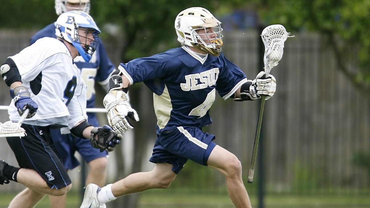 three lacrosse players in a game