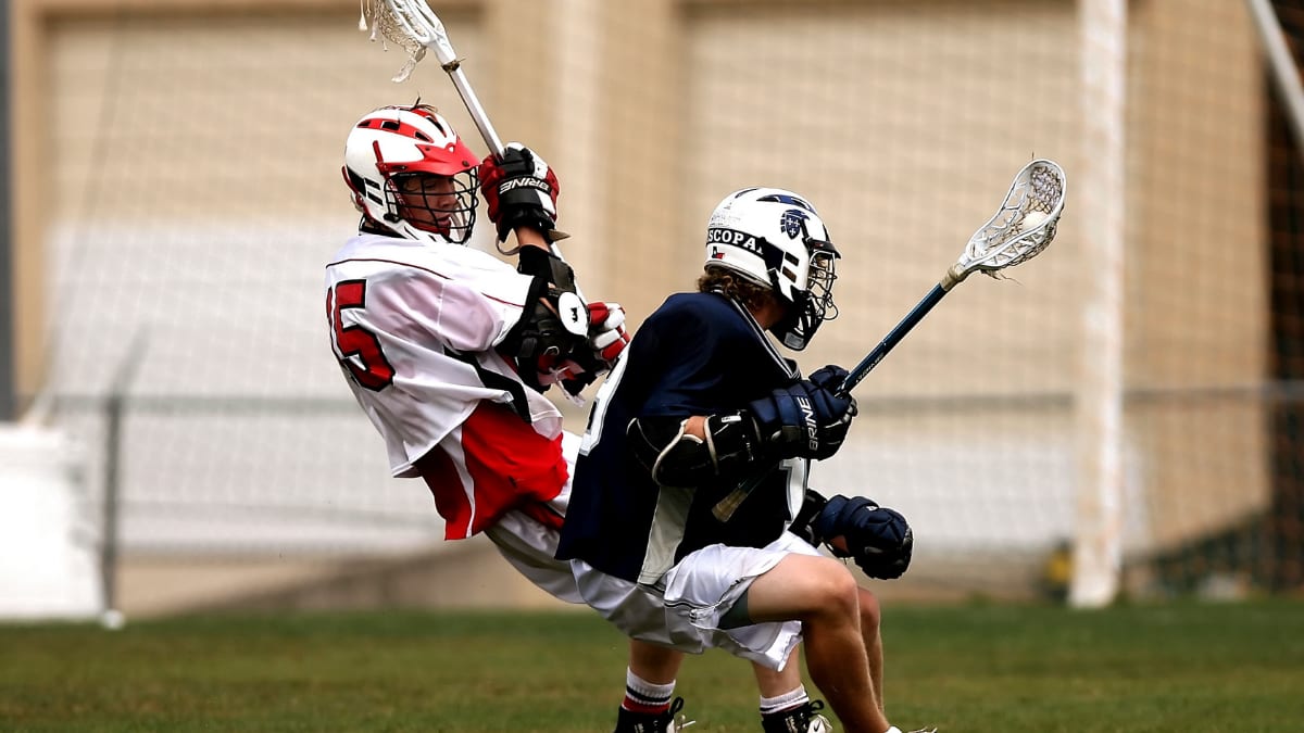 two lacrosse players in a game