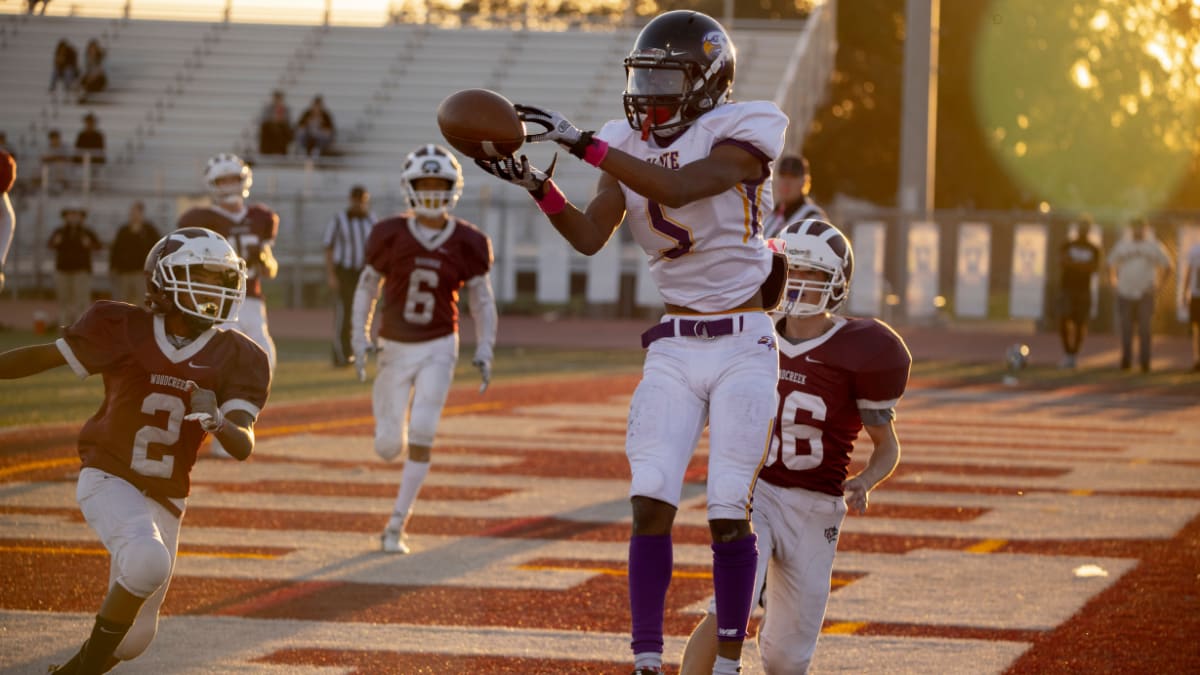 football player catching a football in the endzone