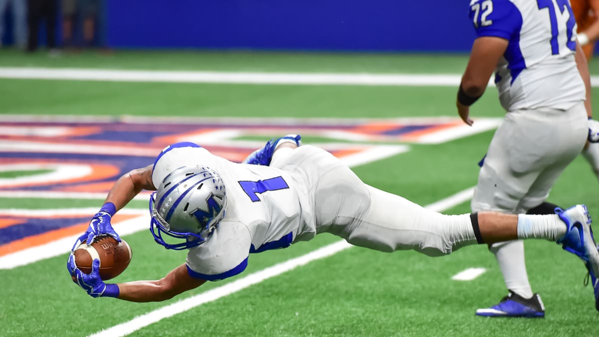 football player catching a football during a game