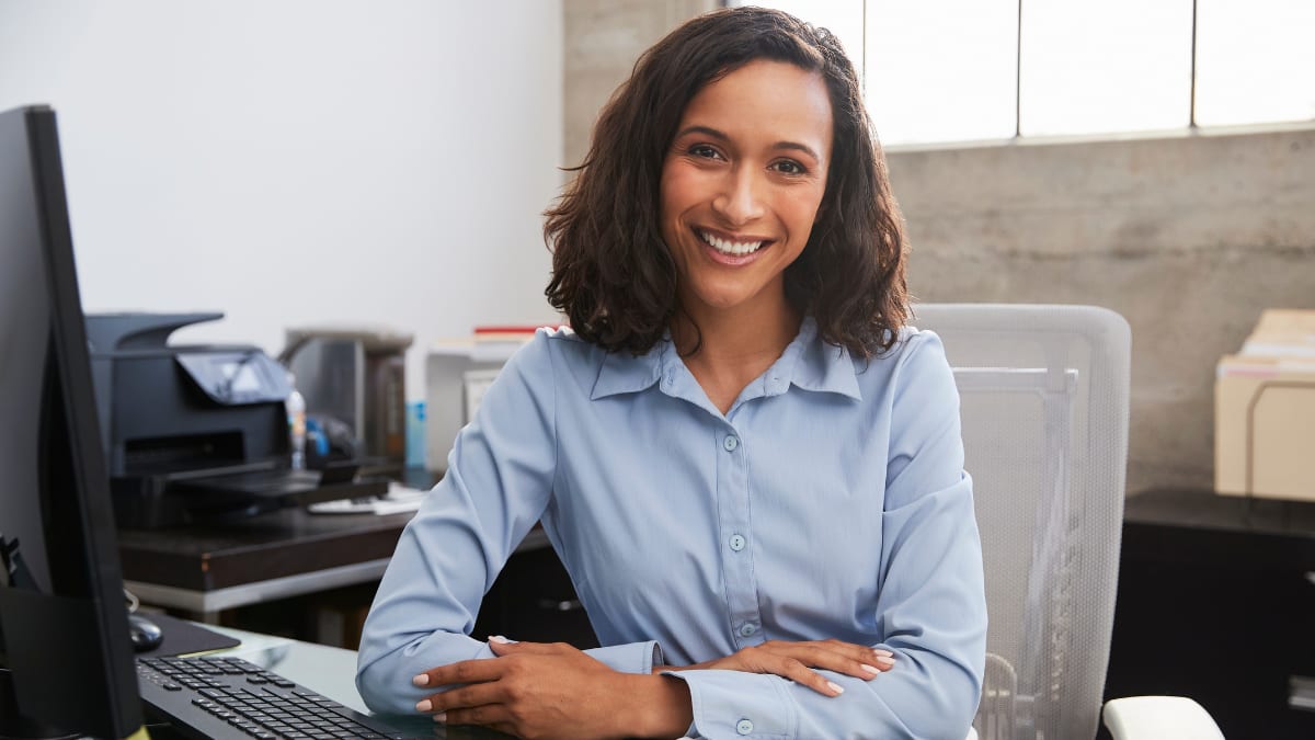 young business professional sitting at her desk in an office