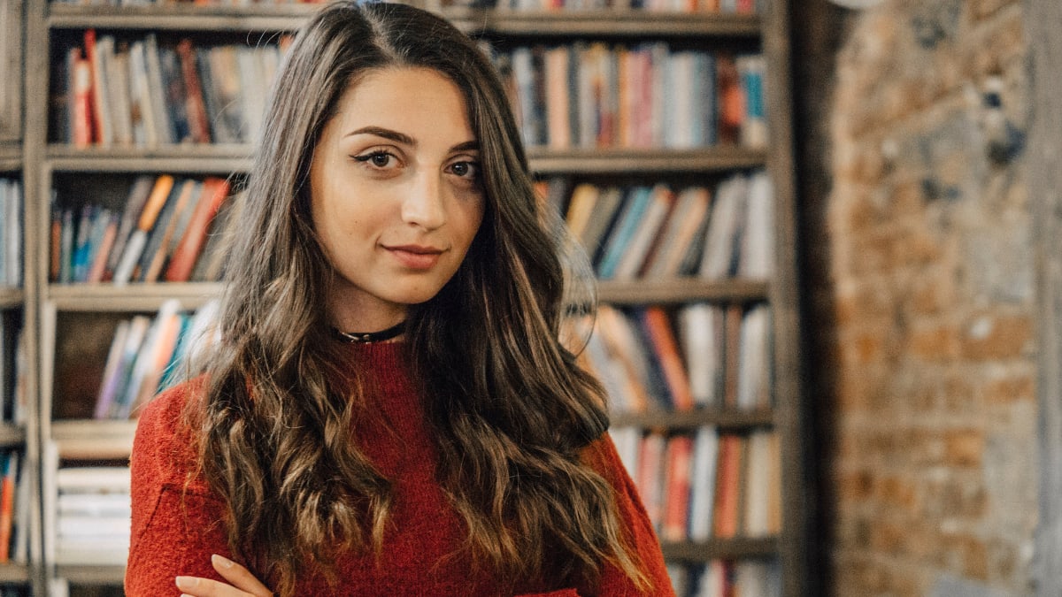 student standing in a college library