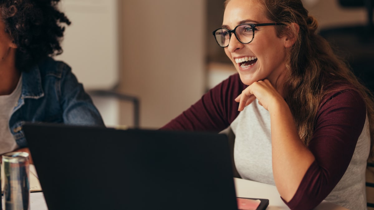 online cyber security student laughing with friends