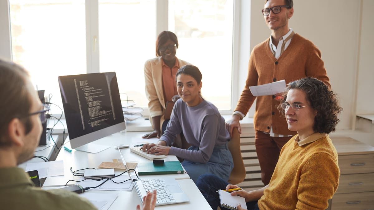 team of software programmers meeting together in an office