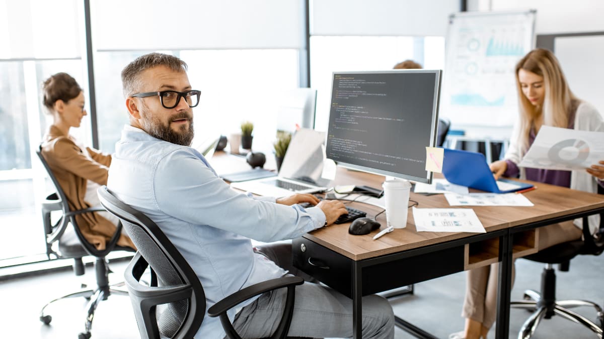 team of cyber security experts sitting together in an office