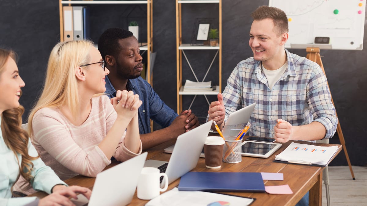 team of information security specialists meeting together in a conference room