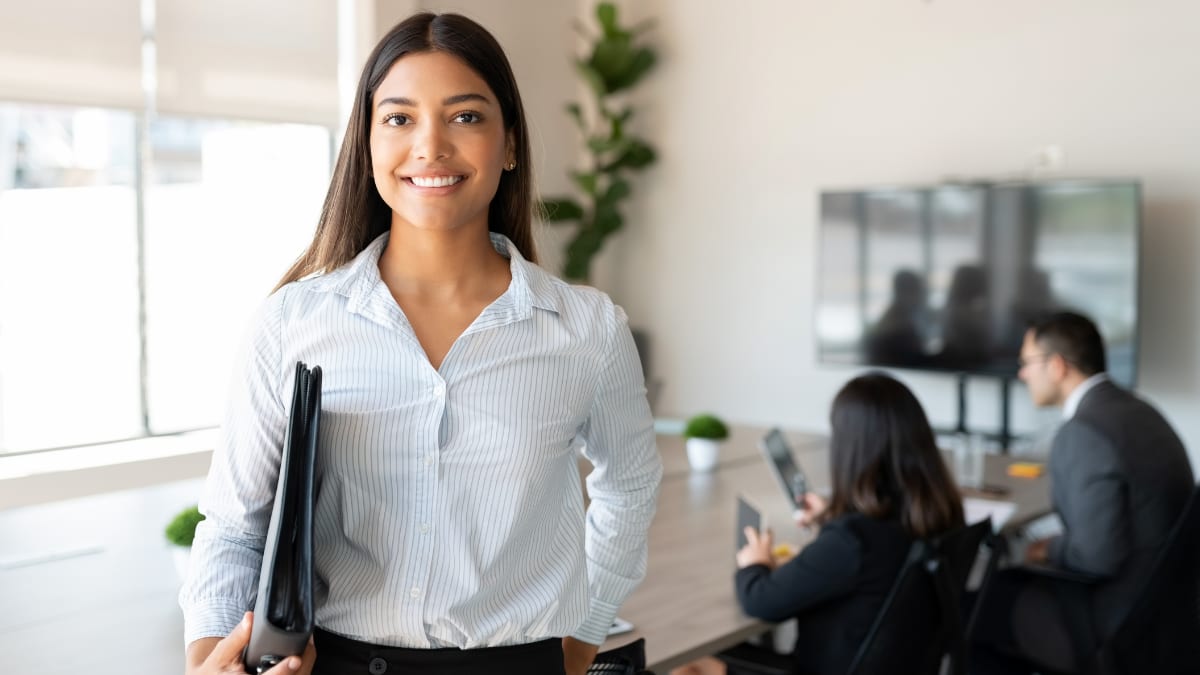 college student standing in an office where she interns