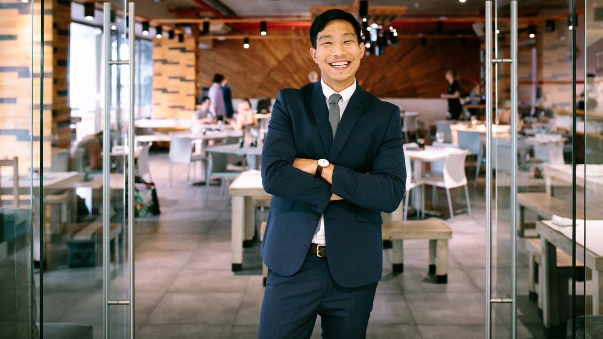 young business professional standing in a restaurant