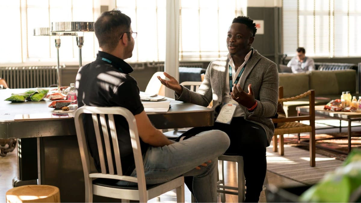 college student sitting with his mentor having a discussion