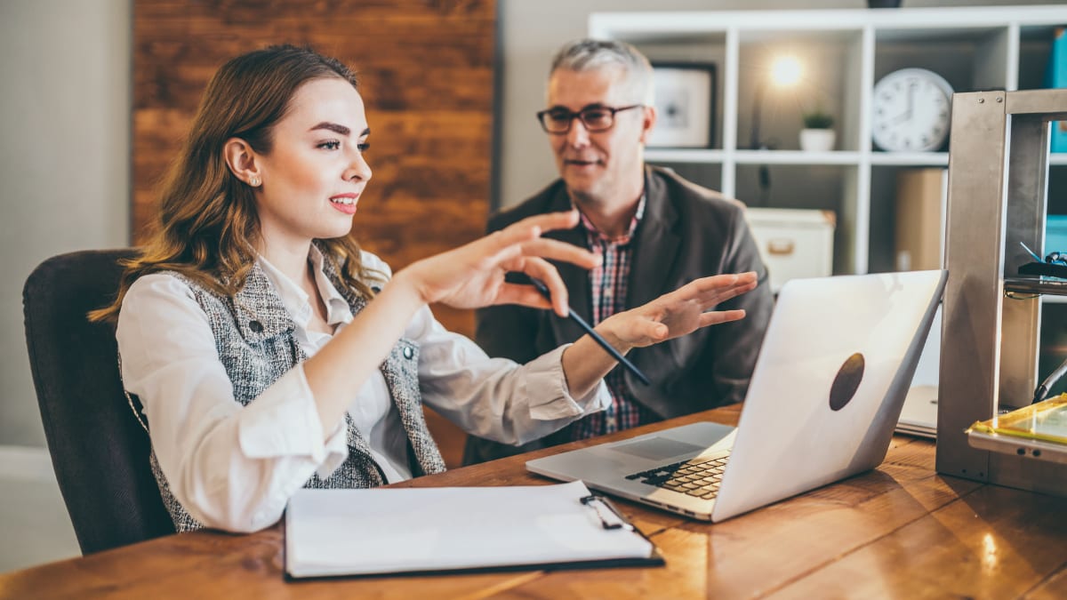 college student meeting with her college mentor to review a project