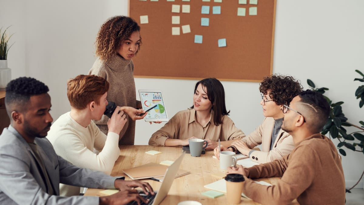 college intern participating in a meeting with a team of business professionals