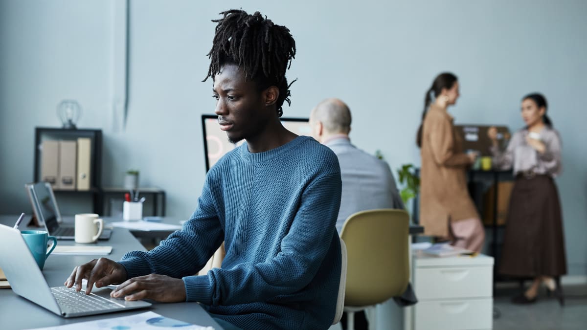 young business professionals working on a laptop in an office