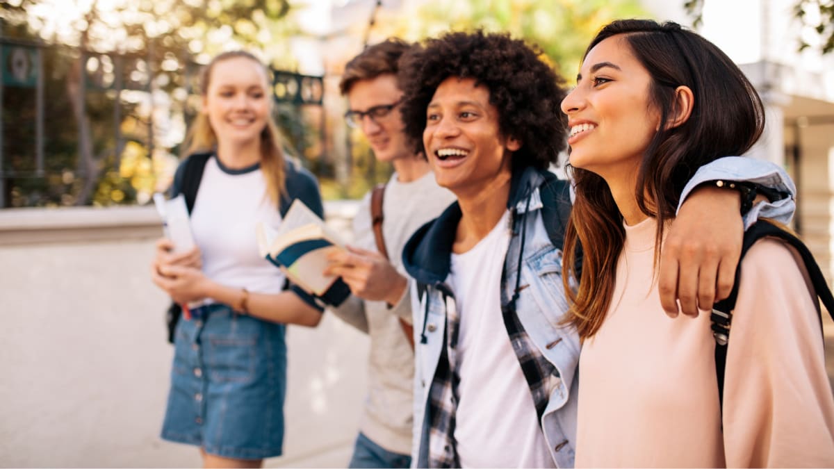 students walking outside on a college campus