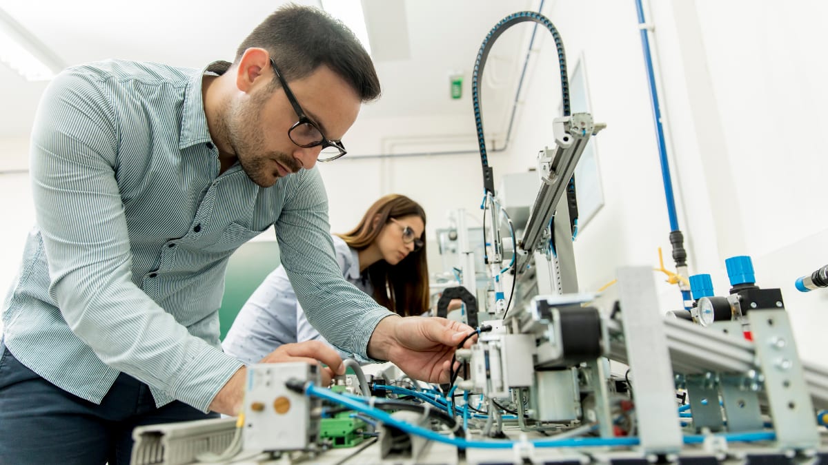two college students in a robotics lab