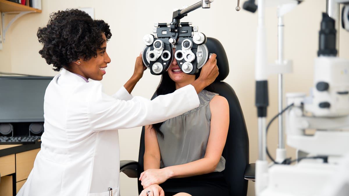 optometrist performing an examination with a patient