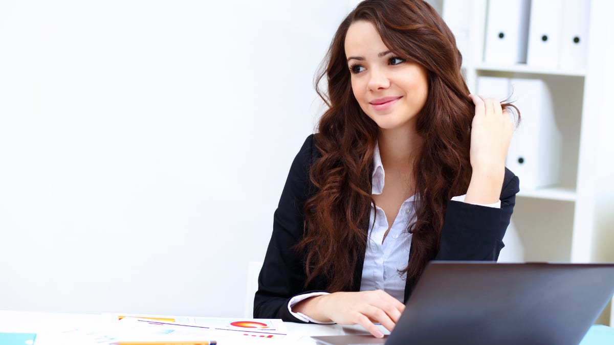 an online MBA student sitting in an office