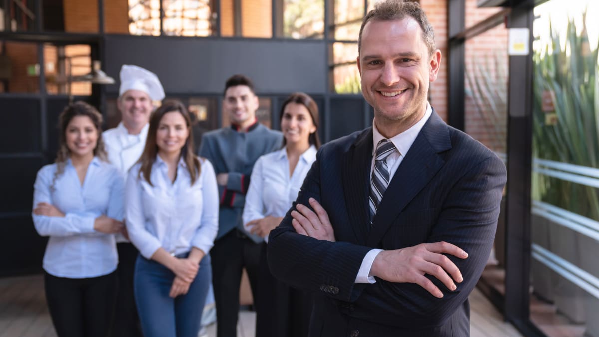 hotel manager standing with his staff