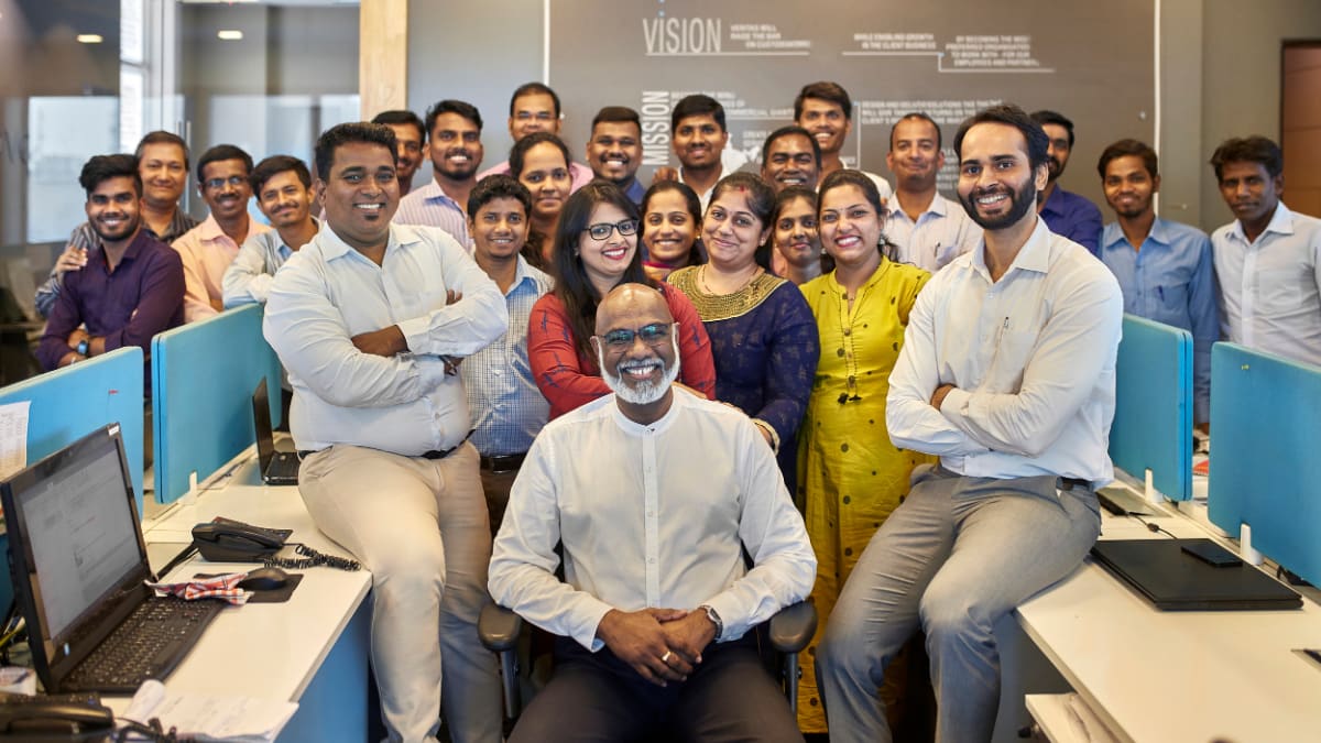 ceo sitting in an office with his team