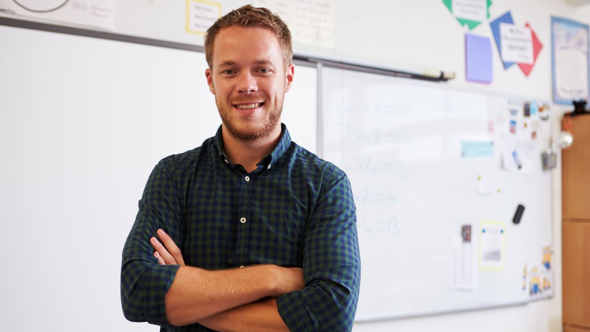 teacher standing in front of a whiteboard