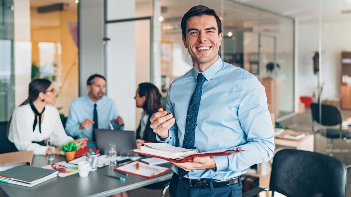 business manager standing in front of his team