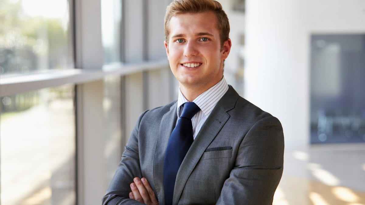 young business professional in a suit standing in an office