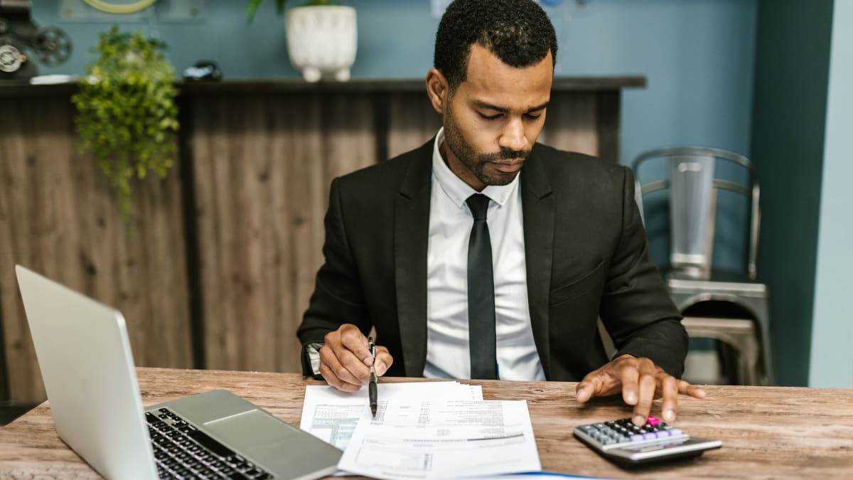 accountant sitting at a desk working on a client's accounts