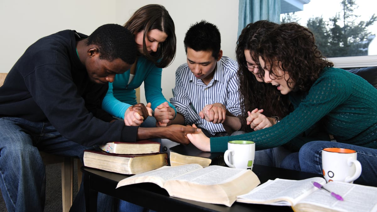 a group of students praying together
