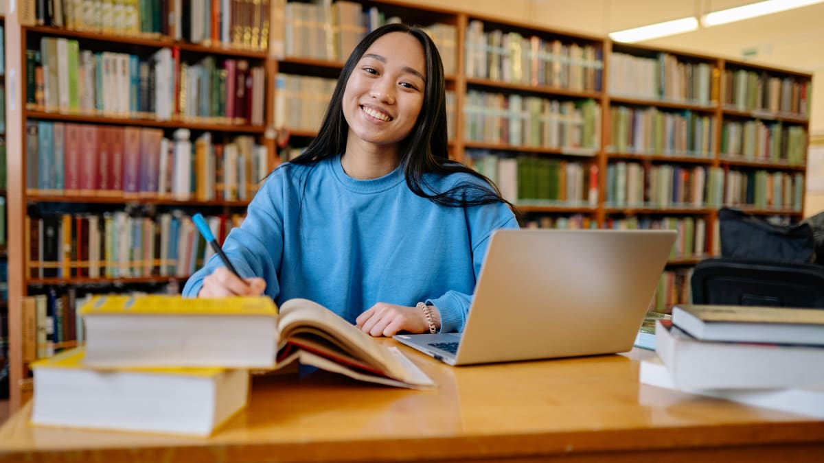 student sitting in a library studying