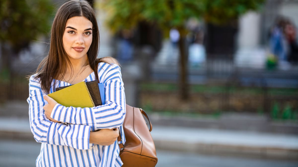 college student standing outside on a college campus