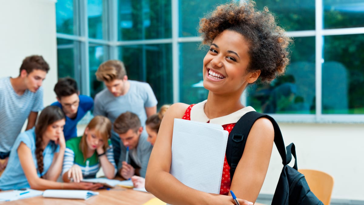 smiling college student wearing a backpack