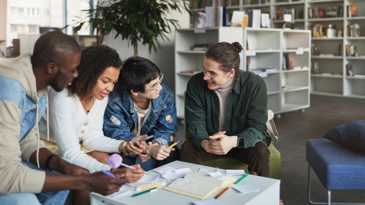 college students meeting together in the college library