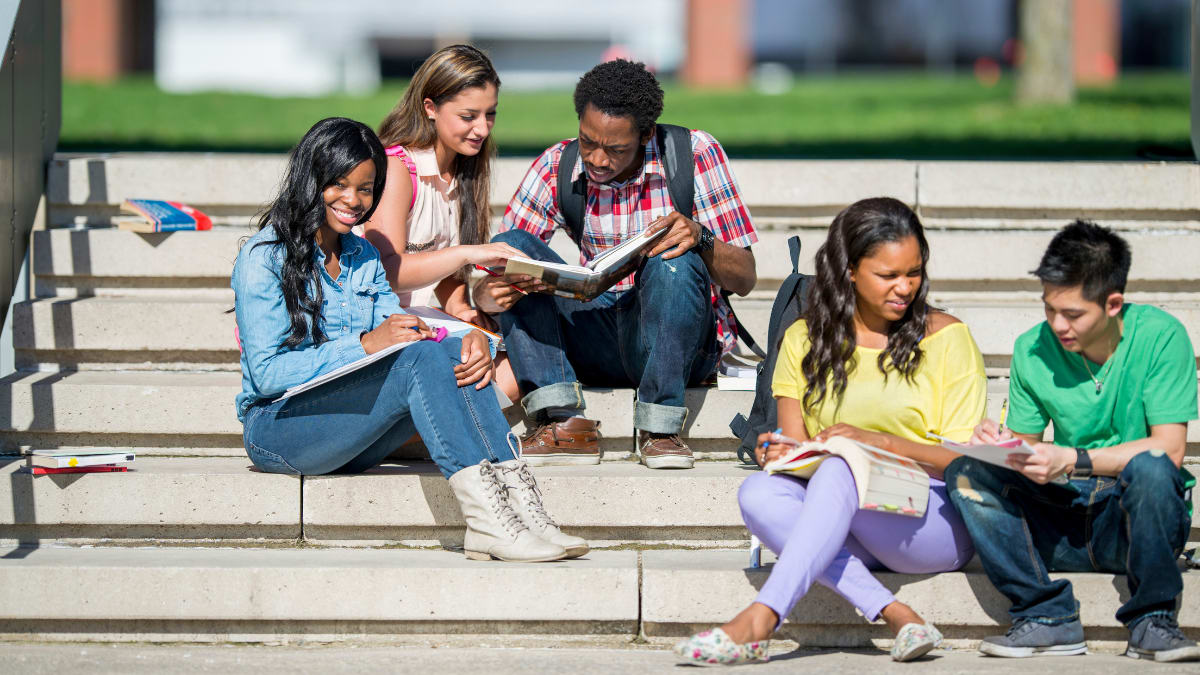 college students sitting on outdoor steps on a college campus