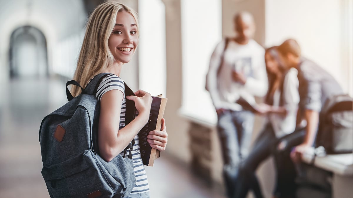 college student standing with other students