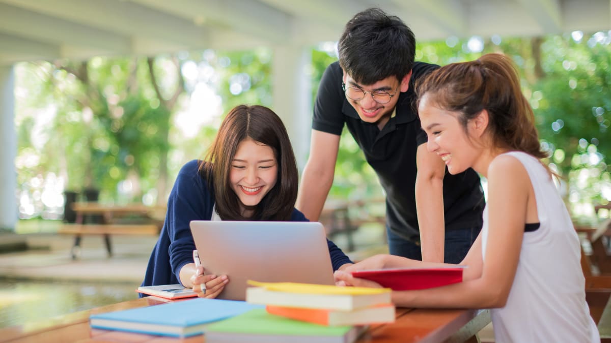 three college students studying together