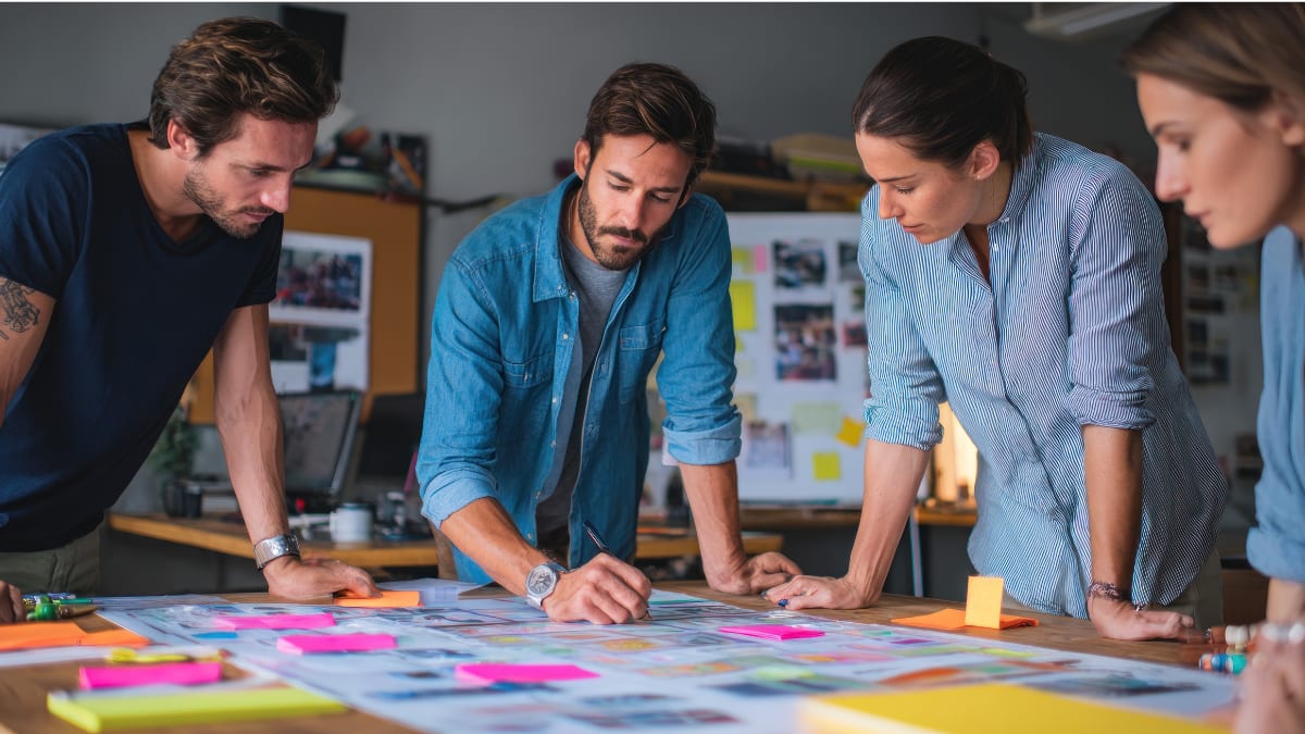 four writers planning a project