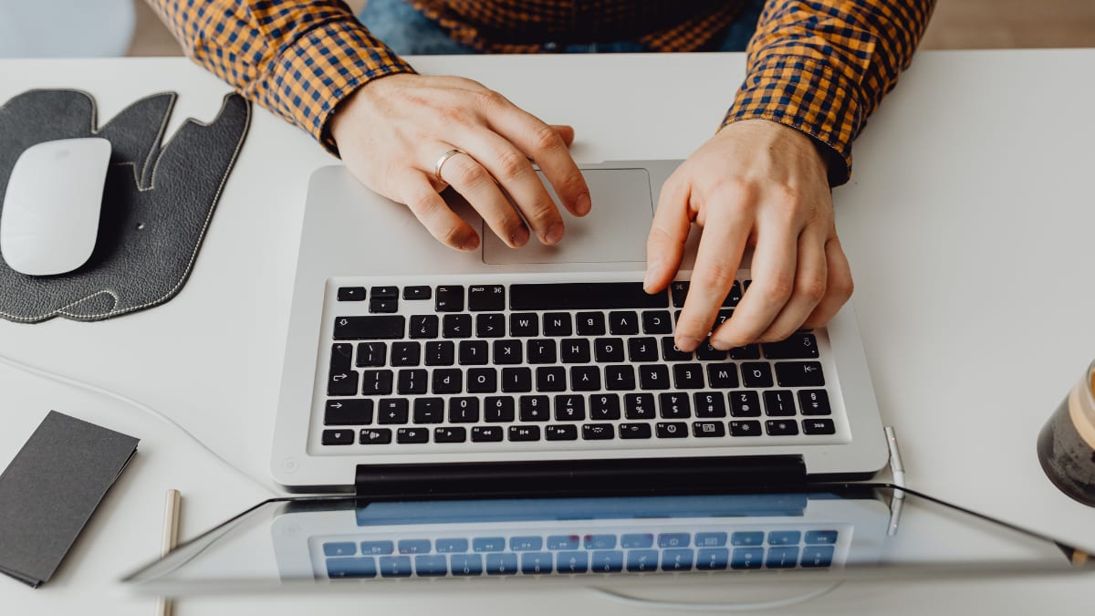 hands typing on a laptop