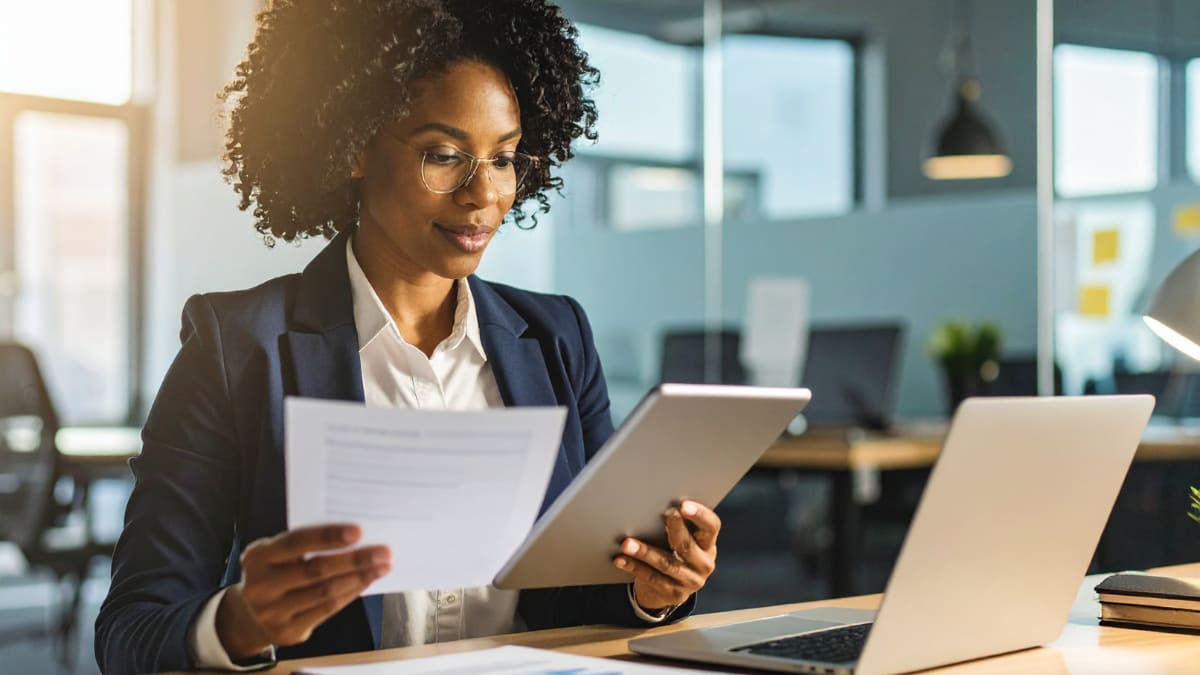 author sitting in an office reviewing a document