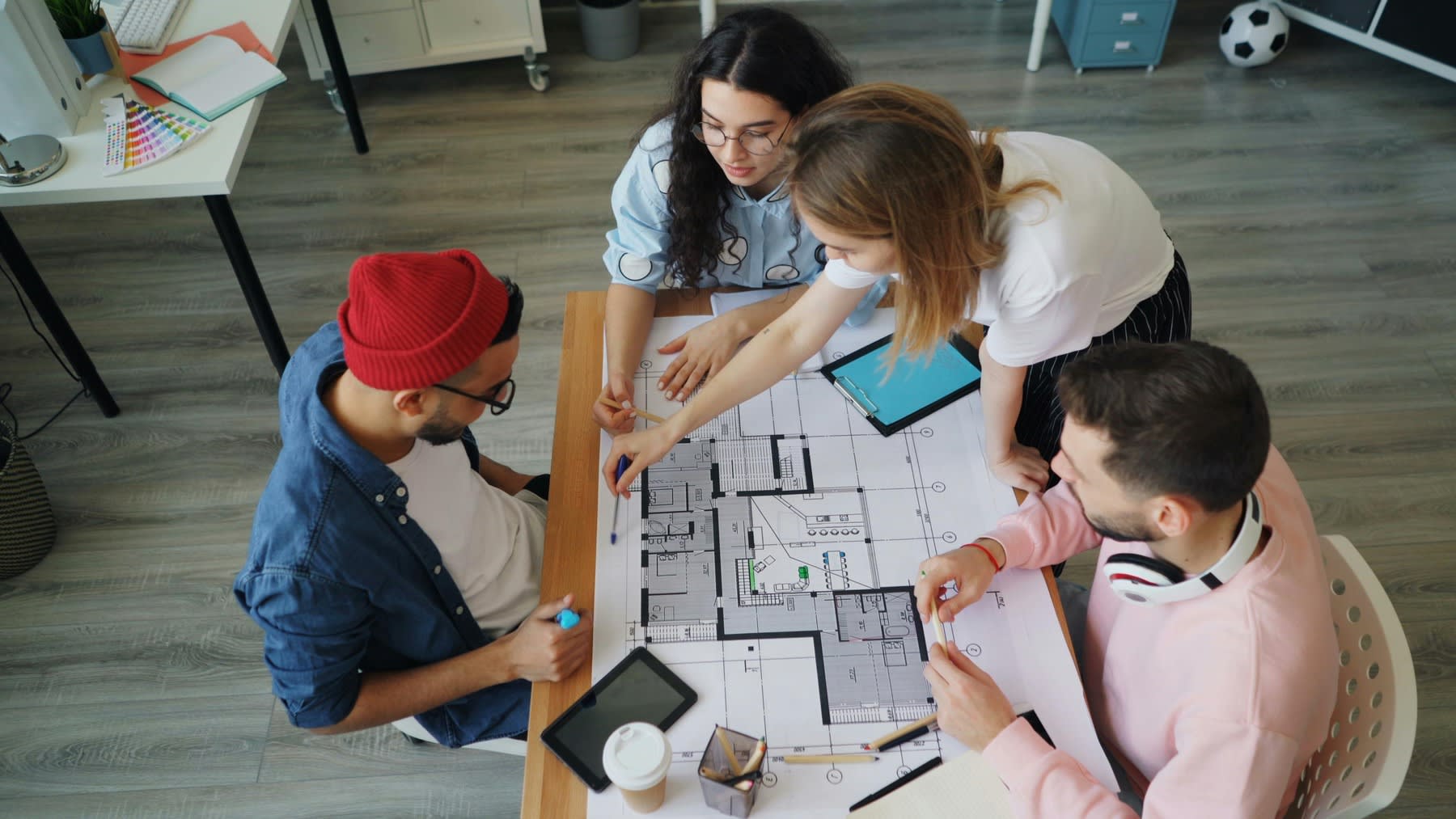 Group of people gathered on a table during a product development meeting