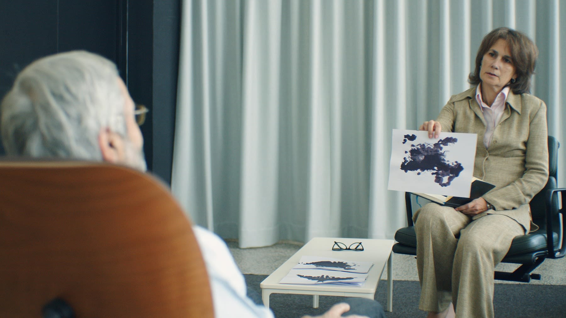 Therapist showing test materials to her patient